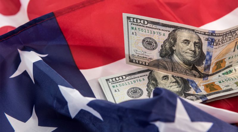 Image of the American flag with two dollar bills laid on it to support US economy article
