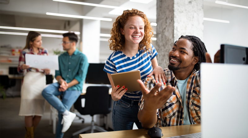 Image of people in the workplace looking happy to support James Clear article