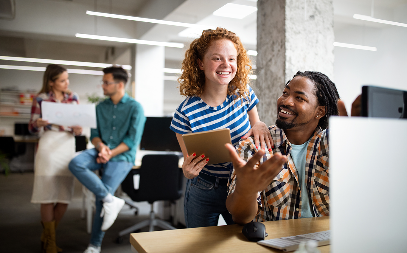 Image of people in the workplace looking happy to support James Clear article