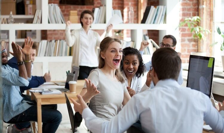 People in an office celebrating success