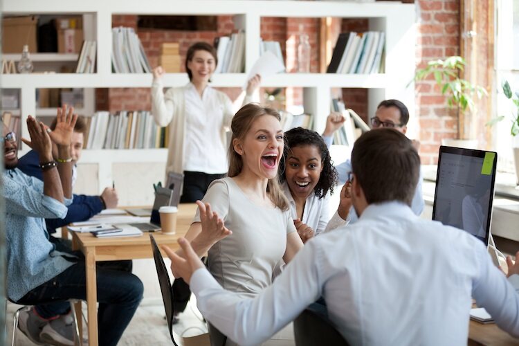 People in an office celebrating success