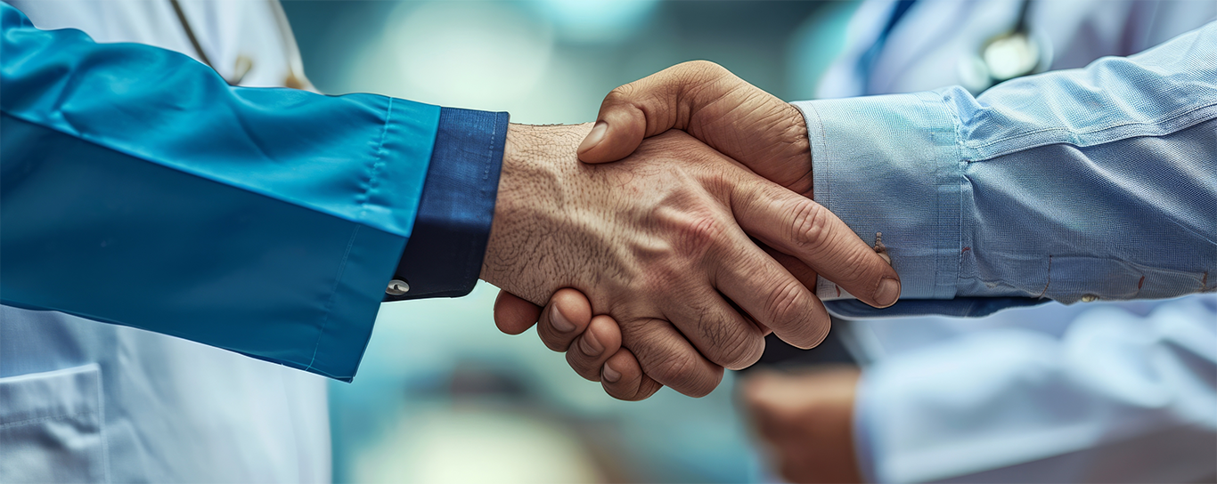 Two business professionals having a handshake to support new Aston Martin CEO article