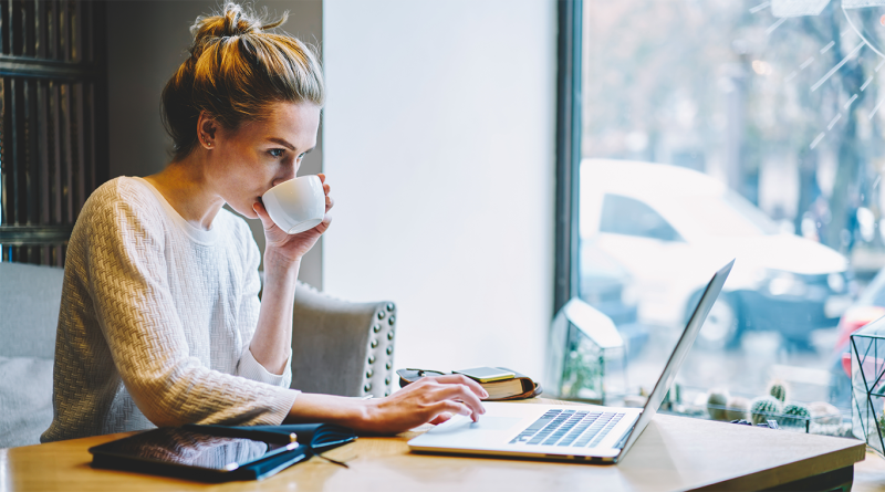Woman sat at desk working on laptop in home environment to support remote and hybrid work article