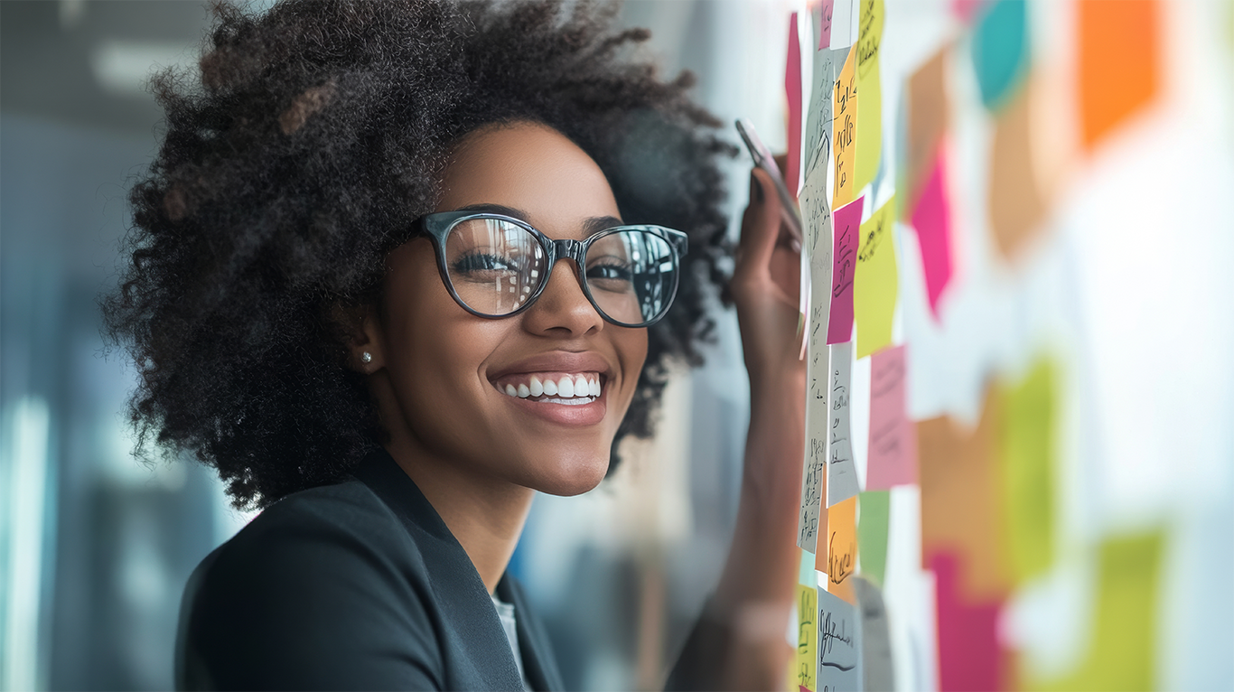 Business woman stood putting ideas into a mindmap to support mindset article