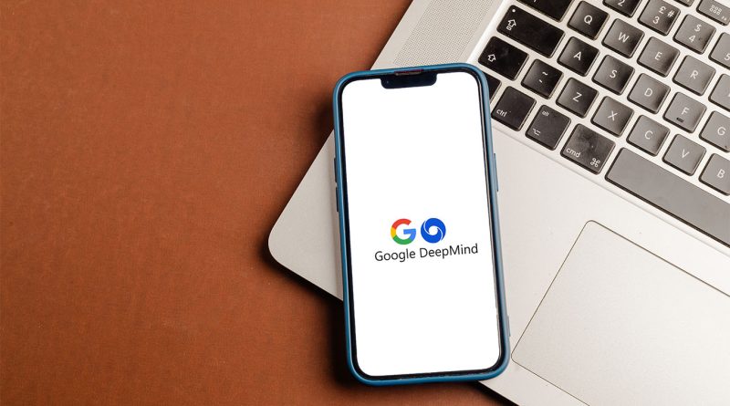 Phone laid on laptop with Google DeepMind displayed on screen