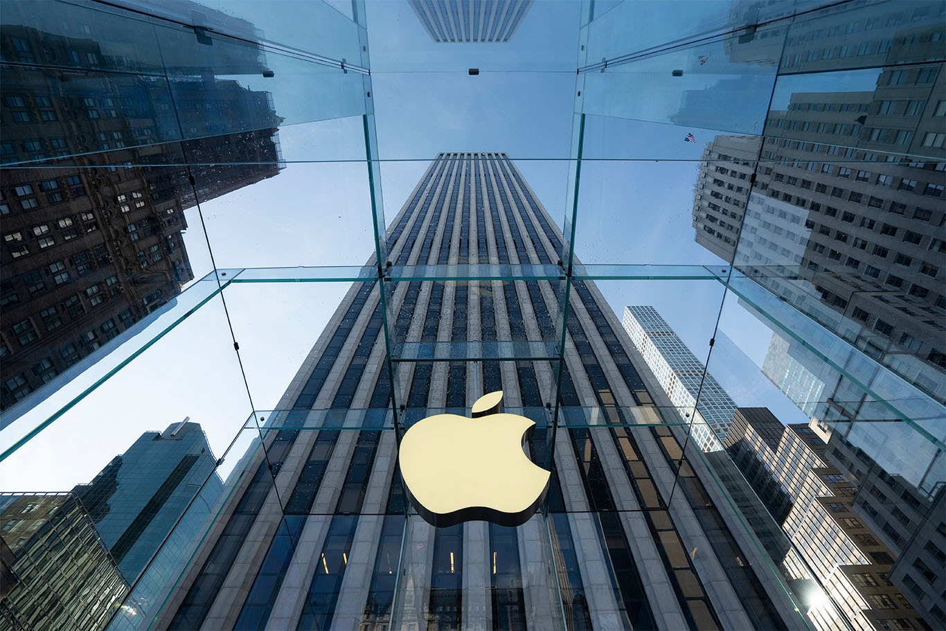 Apple headquarters exterior with John Ternus portrait overlay, symbolizing CEO succession