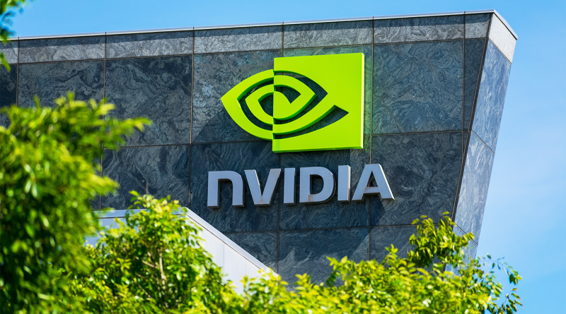 NVIDIA logo and signage on the exterior of a modern building, partially framed by green trees under a clear blue sky.